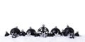 Black christmas balls with snow on white background