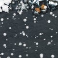 Black Christmas card background with silver decorations and snow on stucco texture Royalty Free Stock Photo