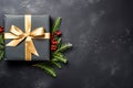 Black Christmas gift box with gold ribbon and ornaments on black background, top view, Christmas background. Generative AI Royalty Free Stock Photo