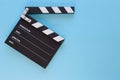 Black clapperboard isolated on color background, flat lay Royalty Free Stock Photo