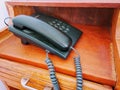 Black clasic telephone on wooden desk