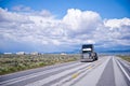 Black classic big rig semi truck transporting commercial cargo o Royalty Free Stock Photo