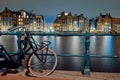 View to historic houses and bike at night in Amsterdam Royalty Free Stock Photo