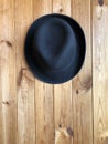 Black classic hat on a wooden background. Royalty Free Stock Photo