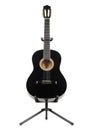 Black classical guitar on a guitar stand Royalty Free Stock Photo