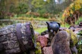 Black clay jug and old wooden barrel on stone pile Royalty Free Stock Photo