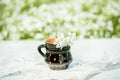 Black clay mug, sunny summer, wildflowers in a vase on a lace knitted tablecloth, lace. A village and vintage, a gentle cozy