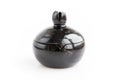 Black clay pomegranate on a white background. original casket with a cover in the form of a pomegranate