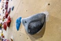 Black climbing gym hold on blurred background.