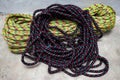 Black climbing ropes are arranged on top of other ropes in a circle