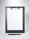 Black Clip board with blank paper and a pen Royalty Free Stock Photo