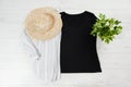 Black closeup t shirt mock up flat lay on white wooden background. Top view and copy space. Mockup t-shirt and summertime. Royalty Free Stock Photo