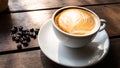 Black coffee bean, white round shape coffee cup on old wooden table top view. lifestyle concept Royalty Free Stock Photo