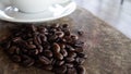 Black coffee bean, white round shape coffee cup on old wooden table top view. lifestyle concept Royalty Free Stock Photo