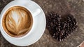 Black coffee bean, white round shape coffee cup on old wooden table top view. lifestyle concept Royalty Free Stock Photo