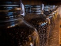 Black coffee beans glass jar packaging package on wood stand at caffe shop Royalty Free Stock Photo