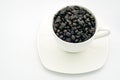 Black coffee beans in white cup. Royalty Free Stock Photo