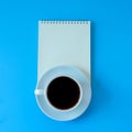 Black coffee with blank booknote on background Royalty Free Stock Photo