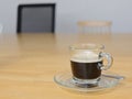 Black coffee in clear glass cup on wood table in meeting room Royalty Free Stock Photo