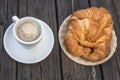 Black coffee and crispy croissant on a wooden table Royalty Free Stock Photo