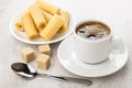 Black coffee in cup, brown lumpy sugar, wafer rolls Royalty Free Stock Photo