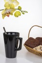 Black coffee cup, chocolate muffins and yellow orchid Royalty Free Stock Photo