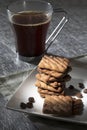 Black coffee cup with cookies and coffee bens Royalty Free Stock Photo