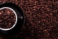 Black coffee cup filled beans background top view Royalty Free Stock Photo