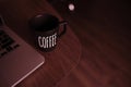 Black coffee cup and a laptop on the desk,copy space