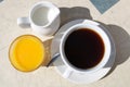 Black coffee cup milk jar orange juice Royalty Free Stock Photo