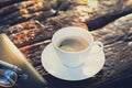 Black coffee in the cup on old dark brown wood background