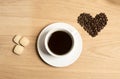 Black coffee in a cup and saucer with biscuits and coffee beans Royalty Free Stock Photo