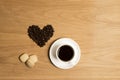 Black coffee in a cup and saucer with biscuits and coffee beans Royalty Free Stock Photo