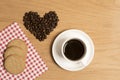 Black coffee in a cup and saucer with biscuits and coffee beans Royalty Free Stock Photo