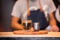 Black Coffee Cup On Wooden Table And Coffee Barista Horizontal and Blurred Background with Film effect. Handsome barista preparing