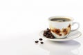 Black coffee with foam in a white ceramic mug and natural coffee beans on a white background Royalty Free Stock Photo