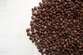 Black coffee grains lie on light wooden table, background image. place for text Royalty Free Stock Photo