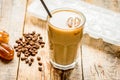 coffee ice cubes and beans with latte on wooden desk background Royalty Free Stock Photo