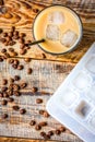 coffee ice cubes and beans with latte on wooden desk background top view Royalty Free Stock Photo