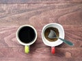 black coffee and instant coffee with silver spoon in cup on desk floor with copy space Royalty Free Stock Photo