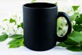 Black coffee mug mockup with apple blossom Royalty Free Stock Photo