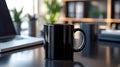 Black coffee mug on modern desk in an office setting Royalty Free Stock Photo
