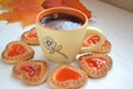black coffee in orange cup with cookies hearts, autumn maple leaf on white table Royalty Free Stock Photo