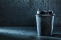 Black coffee papercup on dark background