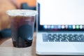 Black coffee in plastic cup with computer laptop Royalty Free Stock Photo