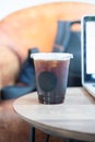 Black coffee in plastic cup with computer laptop Royalty Free Stock Photo