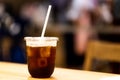 A black coffee on recycle glass and paper straw