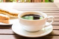 Black coffee served outdoor with wholemeal sandwich bread at the background Royalty Free Stock Photo