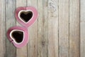 Black coffee in two pink cups heart shape on old wooden floor, Top view, copy space Royalty Free Stock Photo