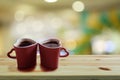 Black coffee in two pink cups heart shape on wooden floor and Colorful bokeh background, Copy space or empty space for text